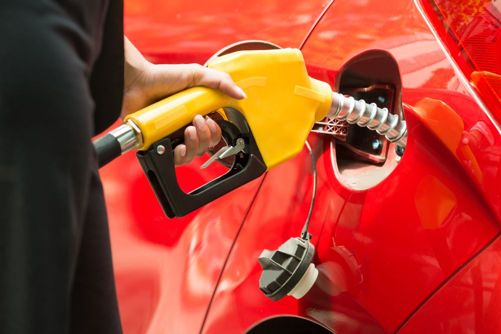 Close-up Of Businesswoman's Hand Refueling Car's Tank